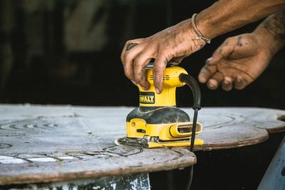 Image of a sander in use. You should know How to Paint Over Semi Gloss Without Sanding