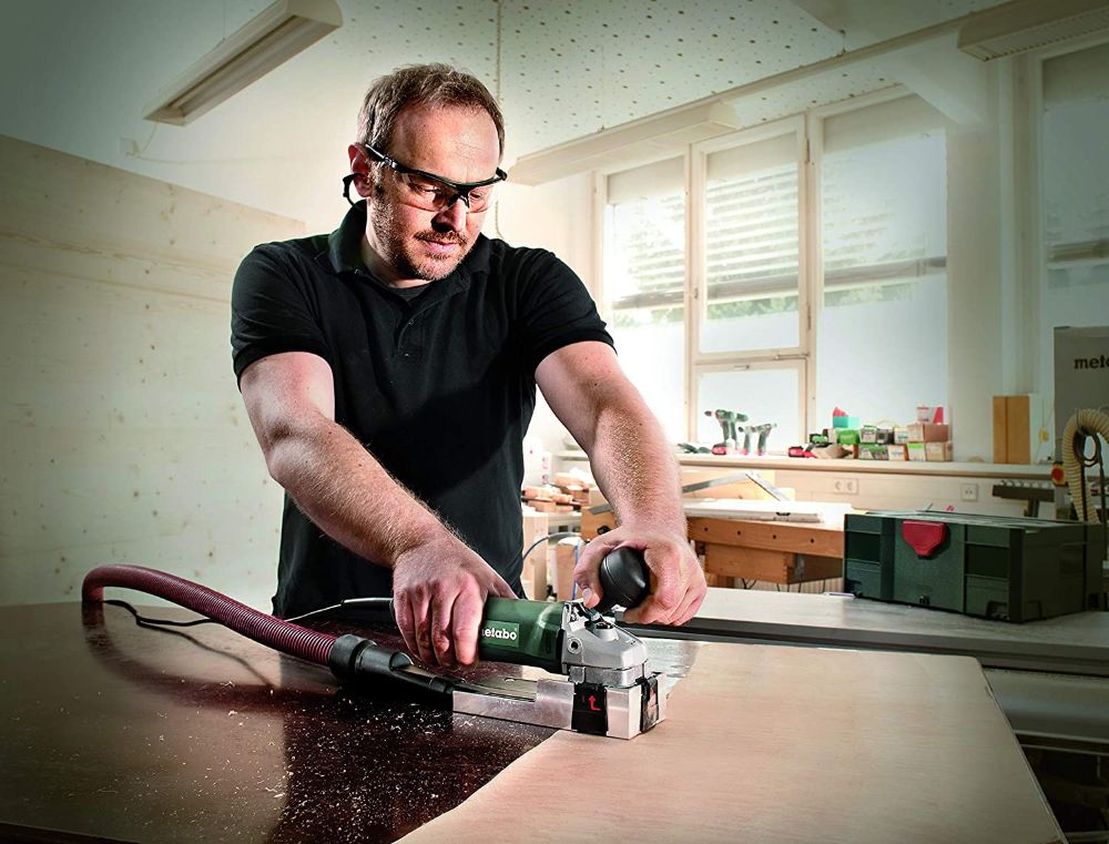 Image of woodworker Using Paint stripper. Stripping is one way of how to remove paint from stained wood